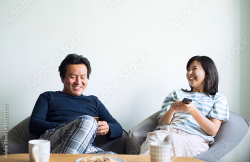 Картината върху платно Asian couple watching movie at home together