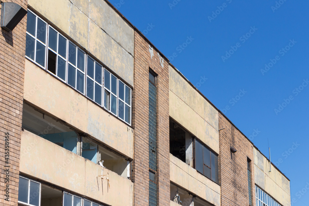 industrial abandoned building against the blue sky industrial abandoned building against the blue sky