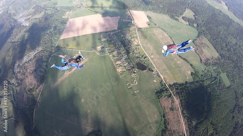 Skydiving. Two skydivers are training in the sky.