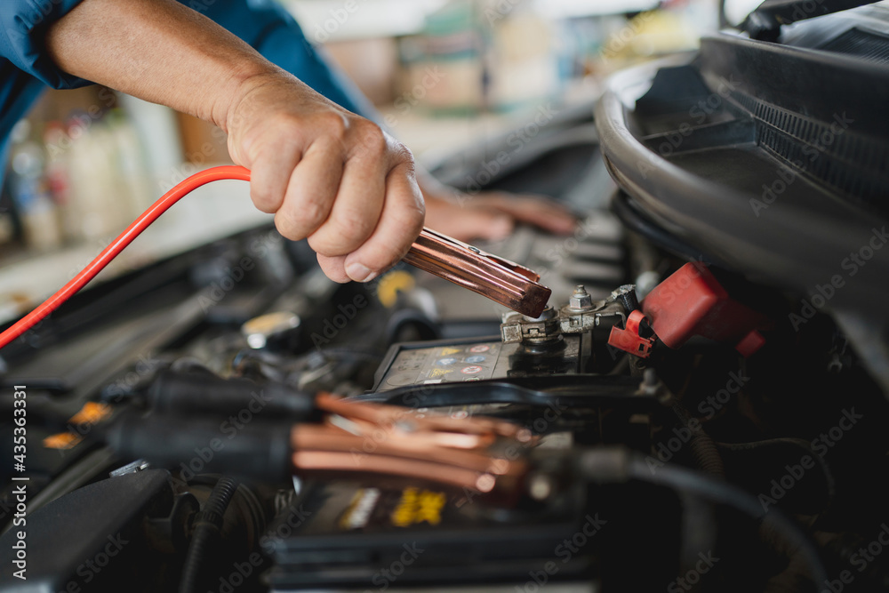 close-up-hands-of-a-car-mechanic-holding-the-battery-jumper-wire-he