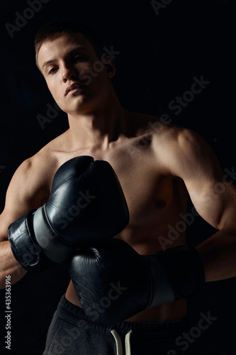 man wearing boxing gloves nude torso black background cropped view model fitness  © SHOTPRIME STUDIO