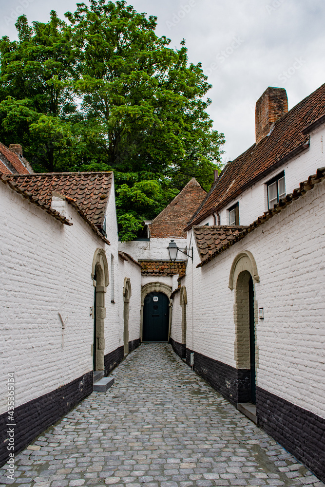 Very narrow street in the medieval beguinage in Courtrai (Kortrijk), UNESCO  World Heritage Site, in west flanders, Belgium.