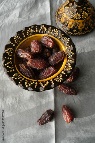 Delicious dates in an inlaid ceramic bowl