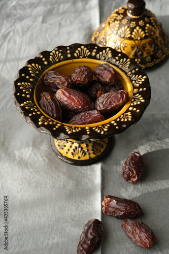 Delicious dates in an inlaid ceramic bowl