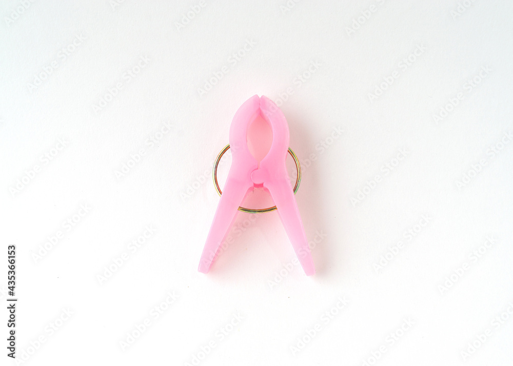 Pink clothespin isolated on white background.