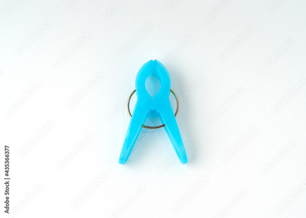 Light blue clothespin isolated on white background.