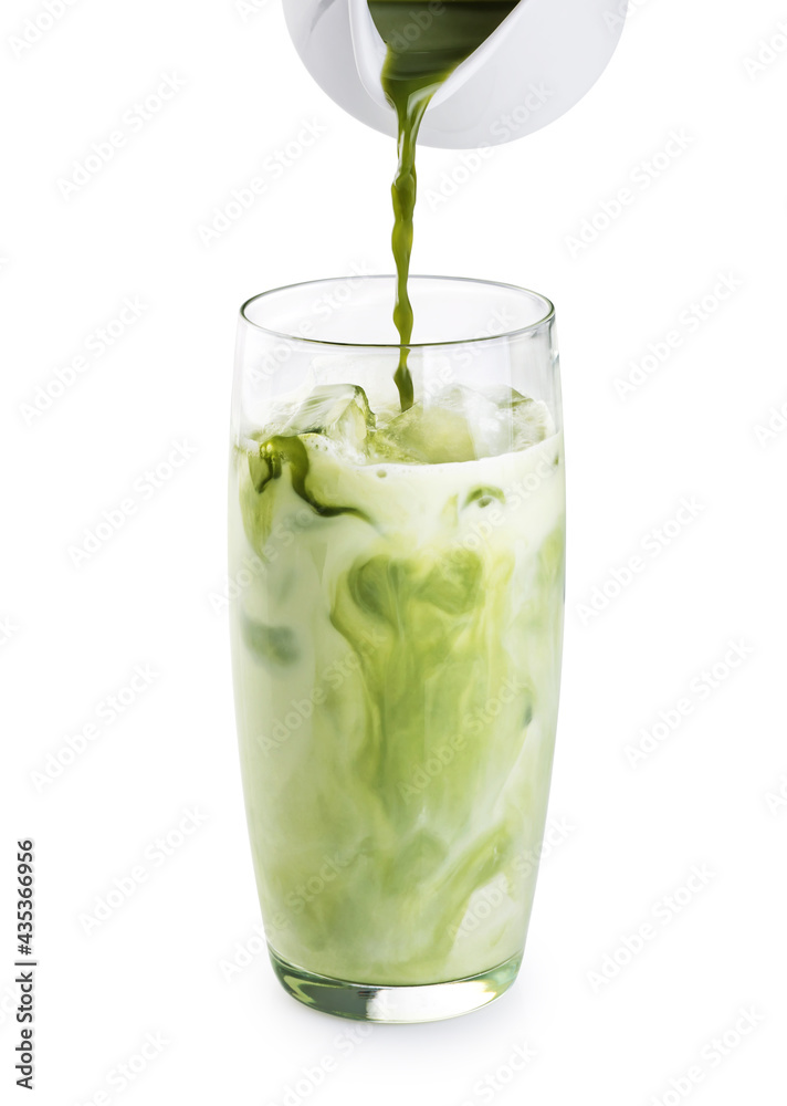 Pouring green matcha into glass with milk and ice isolated on white background. Pouring green matcha into glass with milk and ice isolated on white background.