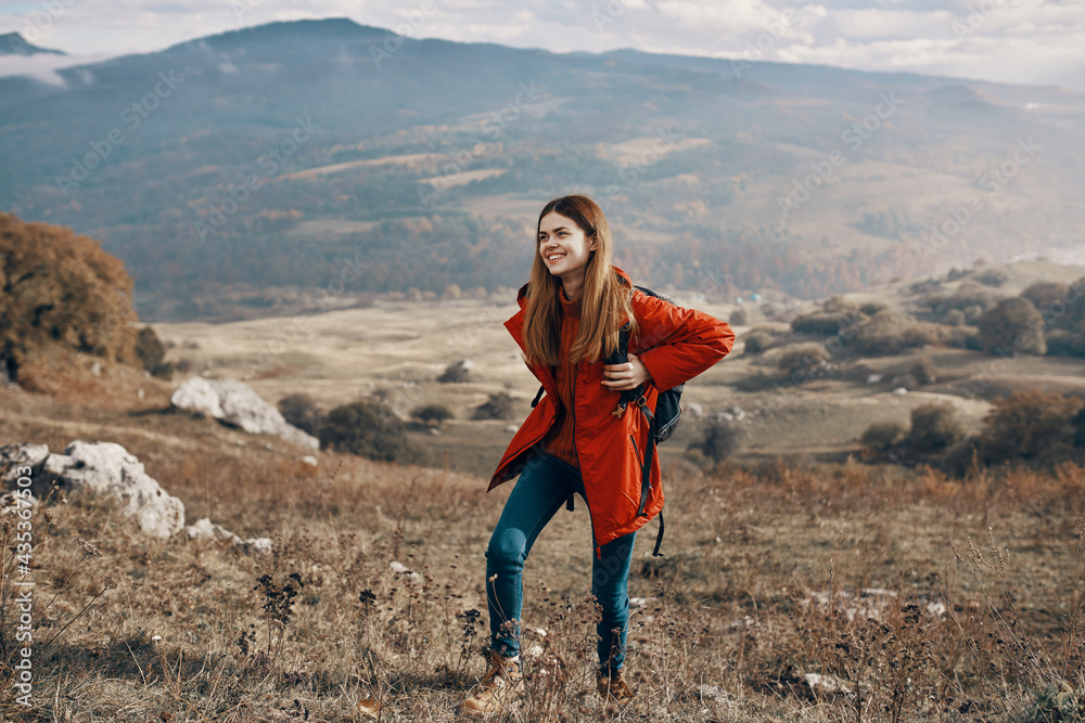 Naklejka premium woman with backpack travel mountains landscape jacket boots jeans
