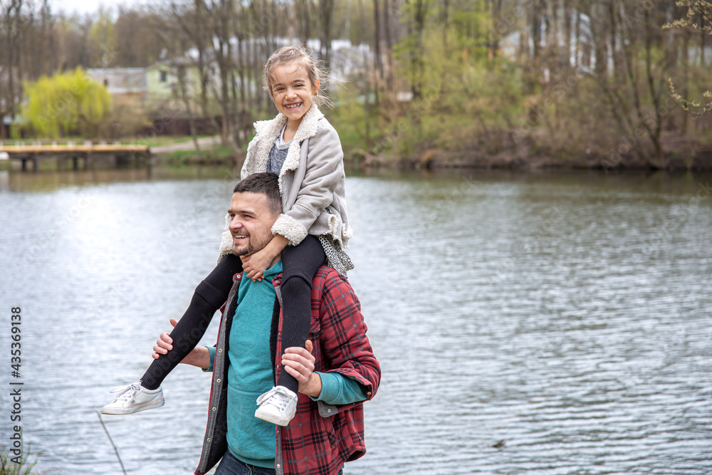 Dad and his little daughter in the woods for a walk by the river. Dad and his little daughter in the woods for a walk by the river.
