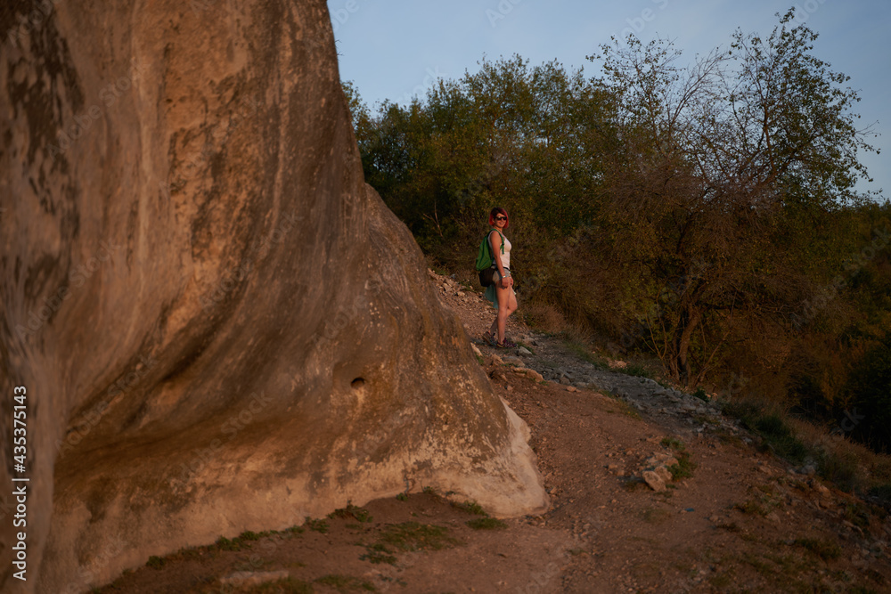 Naklejka premium Young woman walk and looking at the landscape and enjoying the view and fresh air.