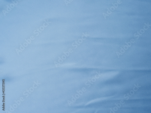 Blue satin texture background with waves and crease