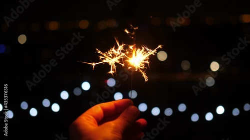 sparklers, sparkler at night on a dark background christmas lights photo