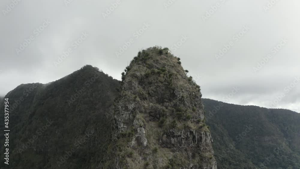 4K drone shot slowly moving towards a mountain peak at Border Ranges National Park, New South Wales Australia. Aerial shot of beautiful nature on a cloudy day.
