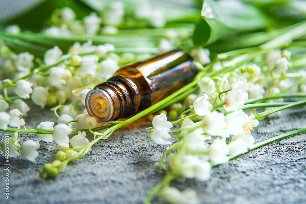 Lily of the valley essential oil in a small bottle. Selective