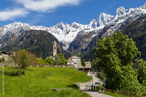 Swiss mountain village Soglio with the snow-covered mountain range Sciora at the background, canton of the Grisons, Switzerland. It is credited as one of the most beautiful Swiss villages.