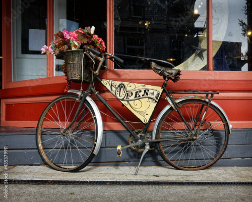 Open for business sign. Retro bicycle open sign outside a shop.