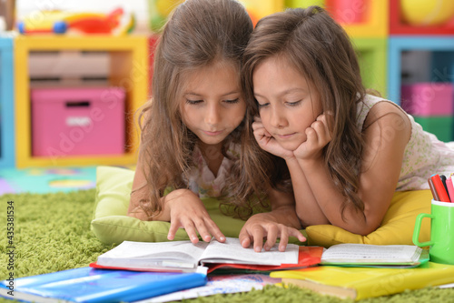 two beautiful little girls studying