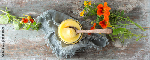 glass jar with ghee on wooden table photo