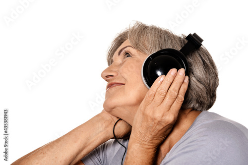 Senior woman listen music in headphones