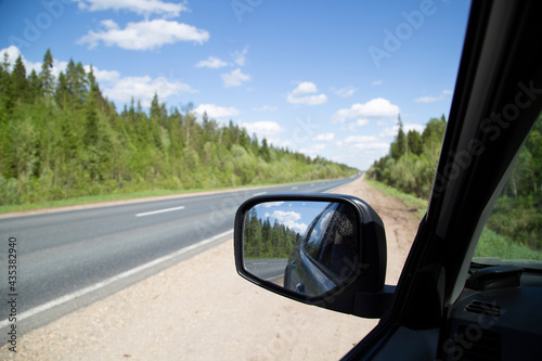 Side rearview mirror. The car is on the highway.Travel by car. © Александр Поташев