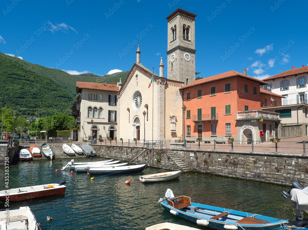 summer landscape on the old port and the square with the bright colors of its buildings in a sunny day.Torno, Como lake, Lombardy, Italy.