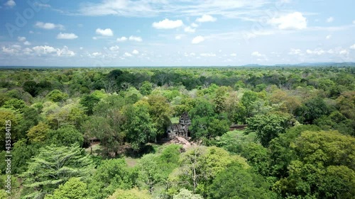 Angkor Temple, Preah Khan Kampong Svay otherwise known as prasat Bakhan. Aerial fly over and reveal in dense rain forest, central Cambodia jungle. photo