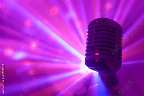 Singer holding retro microphone. Live performance or karaoke concept.