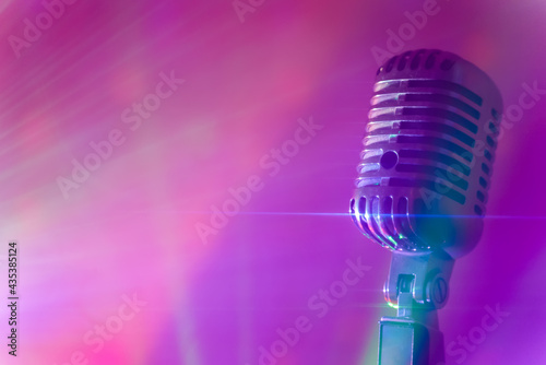 Vintage microphone with stage disco lights. Live performance or karaoke concept.