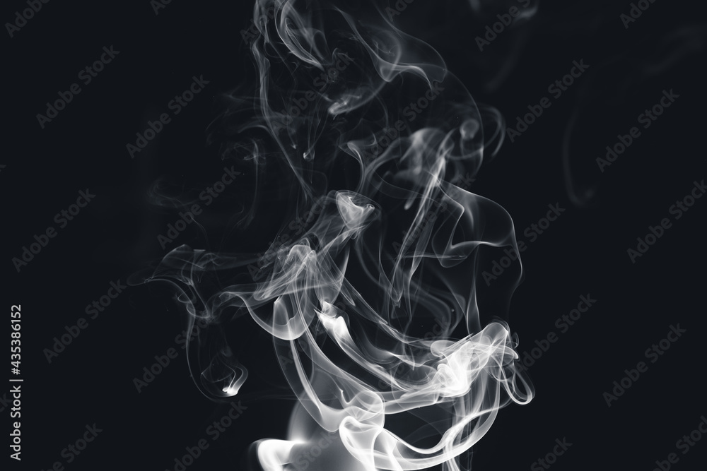 White smoke creating abstract shapes on a black background White smoke creating abstract shapes on a black background