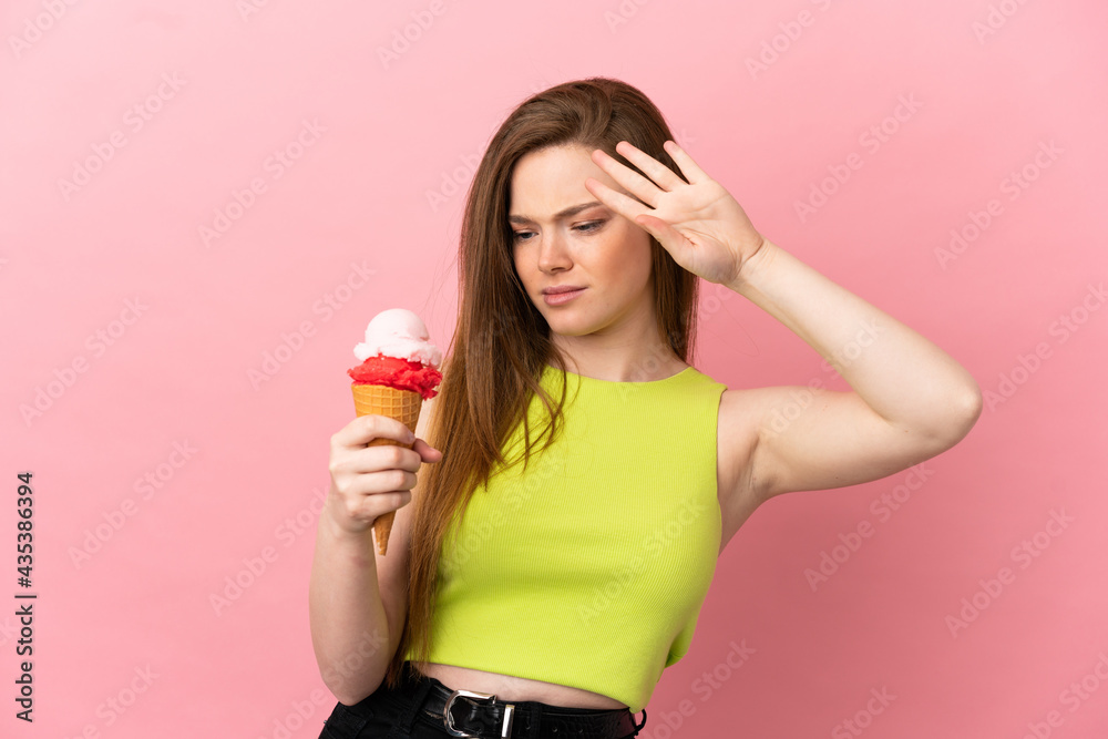 Teenager girl with a cornet ice cream over isolated pink background making stop gesture and disappointed Teenager girl with a cornet ice cream over isolated pink background making stop gesture and disappointed