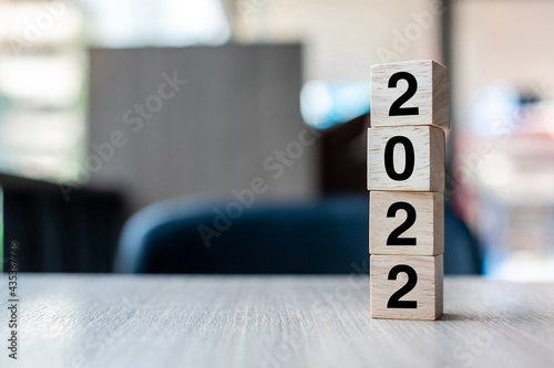 2022 wooden cube block on table background. Resolution, strategy, solution, goal, business and New Year New You and holiday concepts