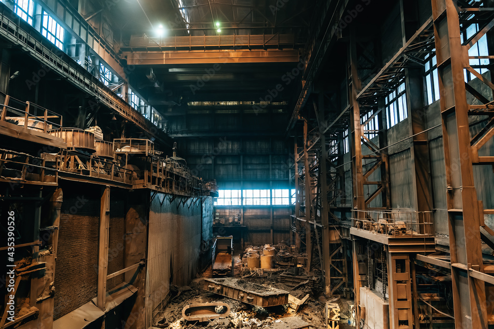 Large industrial warehouse or hangar of foundry with blast furnace, metal waste.