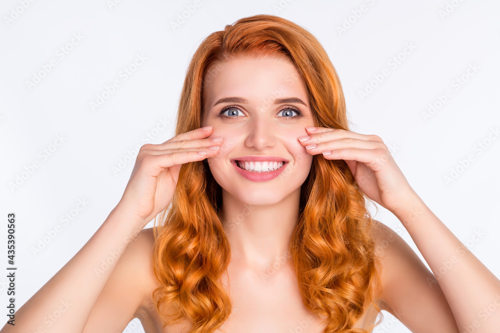 Photo portrait of young model with curly red hair smiling touching smooth soft skin cheeks isolated on white color background Photo portrait of young model with curly red hair smiling touching smooth soft skin cheeks isolated on white color background