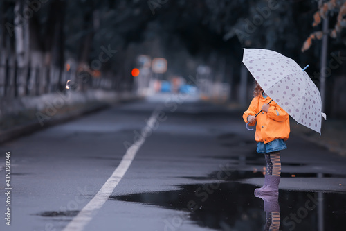 little girl with an umbrella   small child  rainy autumn walk  wet weather child with an umbrella