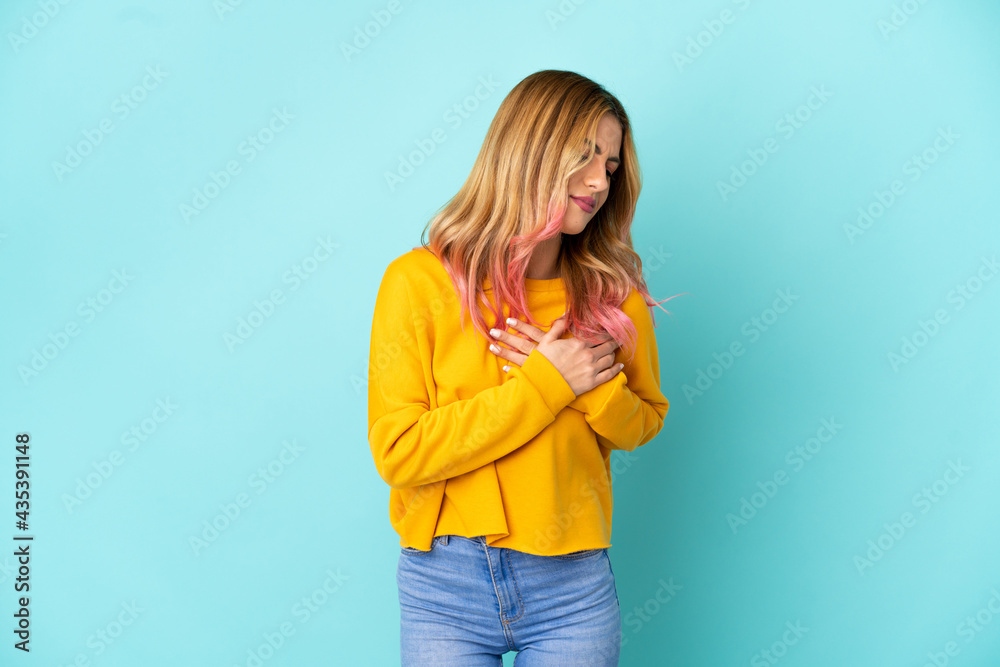 Young woman over isolated blue background having a pain in the heart Young woman over isolated blue background having a pain in the heart