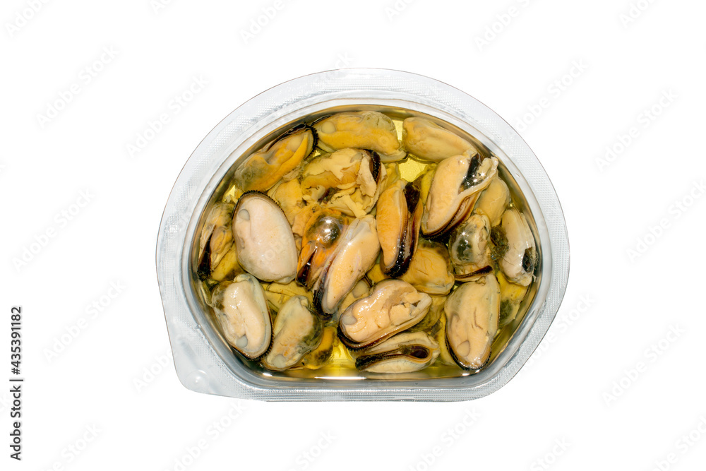 Mussels peeled in oil top view.Mussels in oil in a container on a white background. Mussels peeled in oil top view.Mussels in oil in a container on a white background.