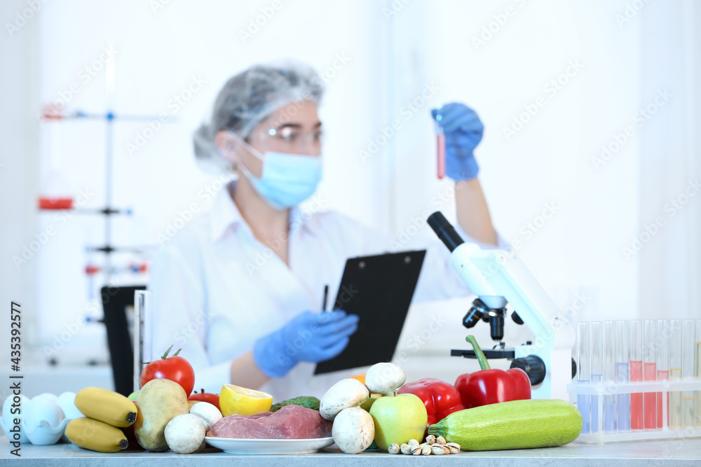 Fresh vegetables, fruits, meat on table and scientist proceeding quality control in laboratory Fresh vegetables, fruits, meat on table and scientist proceeding quality control in laboratory