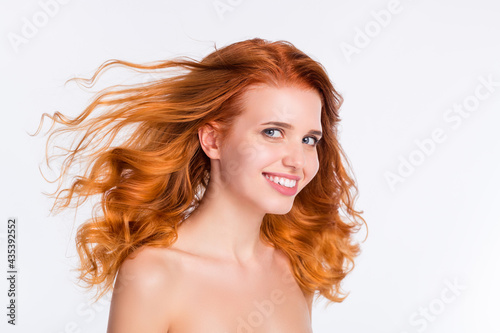 Photo portrait of young woman wavy red hair happy smiling with flying hair naked shoulders isolated white color background