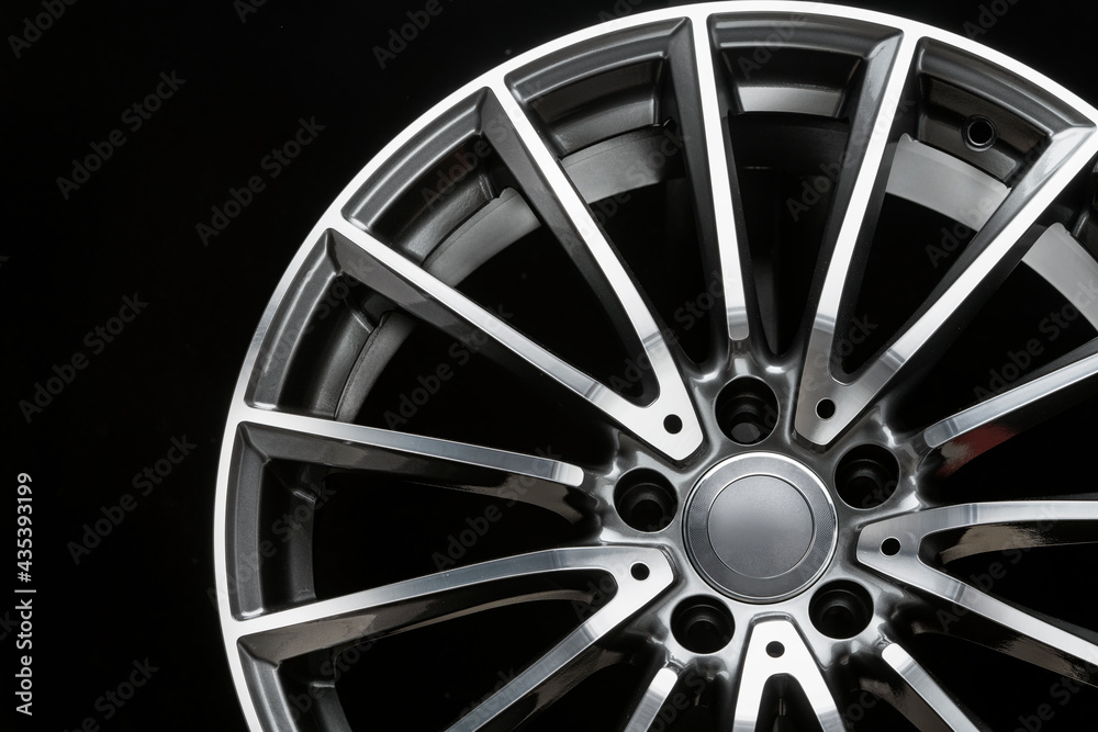 close-up of alloy wheel, thin light spoke, sports car rim, front view