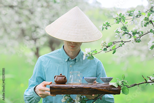 traditional asian tea ceremony in spring blooming garden abstract china background