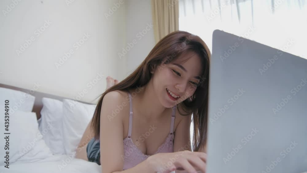 Holiday concept of 4k Resolution. Asian girls working with computers in the bedroom. Holiday concept of 4k Resolution. Asian girls working with computers in the bedroom.