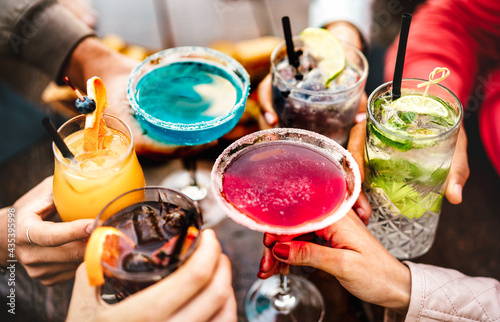 People hands toasting multicolored fancy drinks - Young friends having fun toget Fototapet