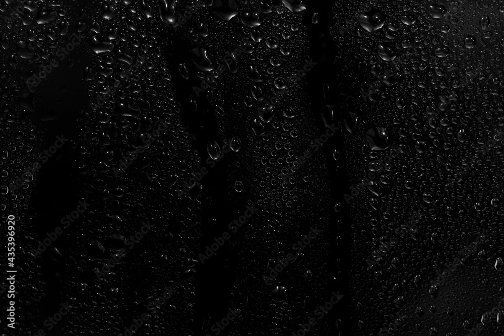 water drops on black background. abstract dew water droplets on a window glass for photo overlay effect or giving fresh effect on beverages mockup.