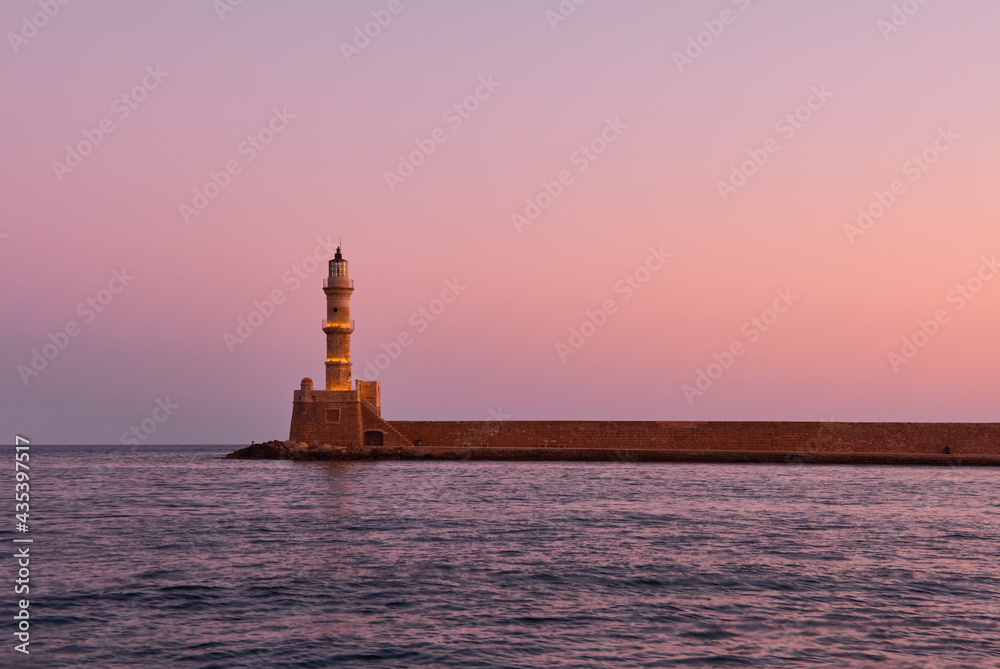 old lighthouse of Ghania in red dawn and calm mediterranean sea