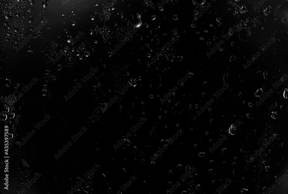 water drops on black background. abstract dew water droplets on a window glass for photo overlay effect or giving fresh effect on beverages mockup.