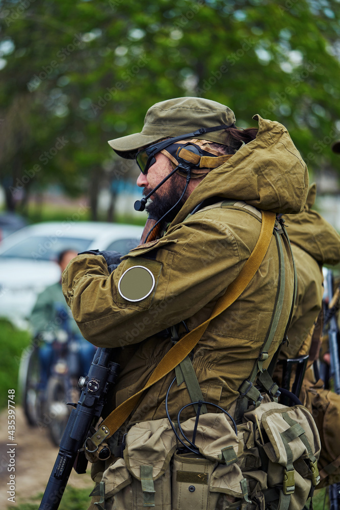 Airsoft player in military uniform waiting for the start of the game