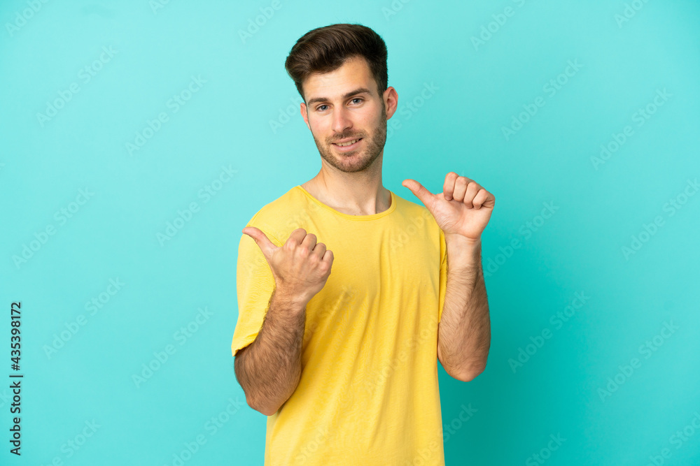 Young caucasian handsome man isolated on blue background pointing to the side to present a product Young caucasian handsome man isolated on blue background pointing to the side to present a product