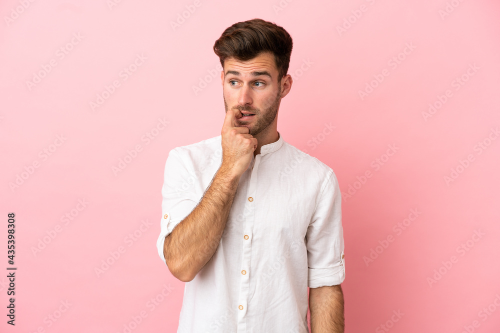 Young caucasian handsome man isolated on pink background nervous and scared Young caucasian handsome man isolated on pink background nervous and scared