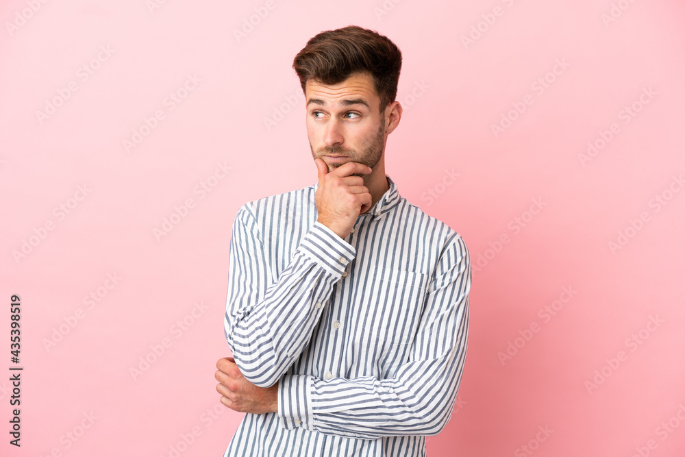 Young caucasian handsome man isolated on pink background thinking an idea while looking up Young caucasian handsome man isolated on pink background thinking an idea while looking up
