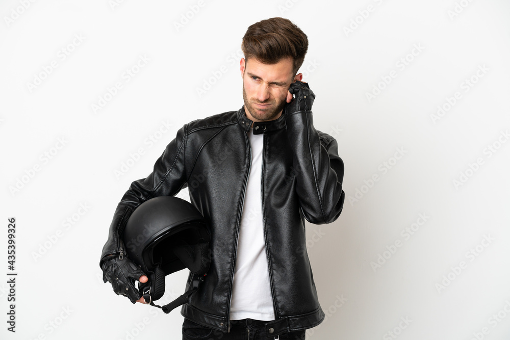 Young caucasian man with a motorcycle helmet isolated on white background frustrated and covering ears Young caucasian man with a motorcycle helmet isolated on white background frustrated and covering ears